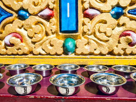 Prayer silver bowls in the row, Dharmshala India の写真素材