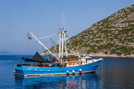 Typical Mediterranean fishing boat in the sea near coast preparing for fishing. Location Peljesac peninsula, Croatiaの写真素材