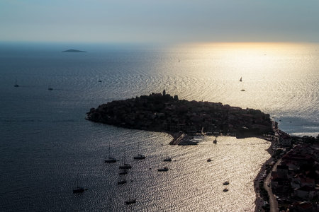 Primosten old town panorama at sunset. Helicopter aerial shoot.