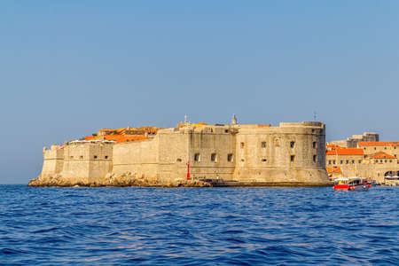Dubrovnik old city defense walls details shot from a boat  St  John fortress at the harbor entrance  Location Croatia - Europe の写真素材