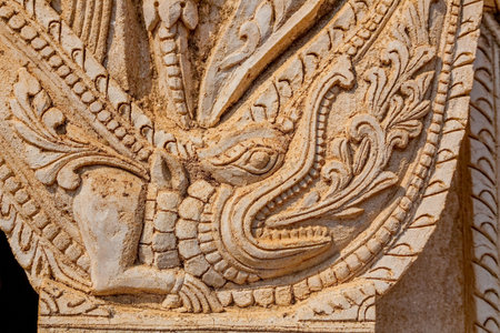Ancient white small pagoda in old Bagan with beautiful stucco details on the facade aove the portal, Burma (Myanmar).の写真素材