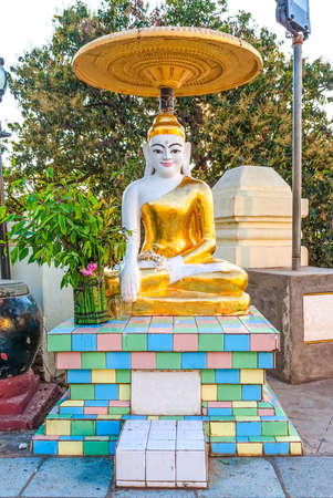 BAGAN, MYANMAR - FEB 22: Golden Buddha sculpture in front of Bupaya stupa on Feb 22, 2012 in old Bagan, Myanmar.のeditorial素材