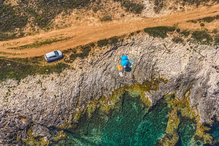 Aerial view of footpath near coast made for tourist trekking and camping. Rocky beach in Istria, Croatiaの写真素材
