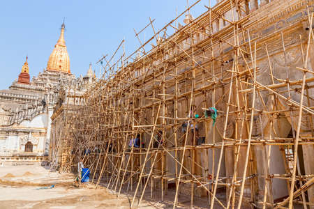 BAGAN, MYANMAR - FEBRUARY 23: Restoration of ancient Ananda Temple with bamboo scaffolding in front on February 23, 2013 in Bagan, Myanmar. Built in 1105 AD during the reign of King Kyanzittha of the Pagan Dynasty.のeditorial素材