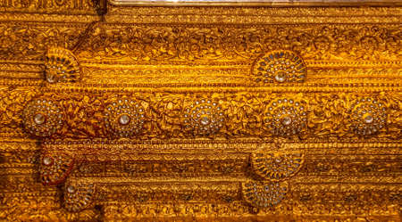 MANDALAY - FEBRUARY 26: Buddha statue pedestal
 detail taped with golden leaves at Mahamuni Buddha temple on February 26, 2013 in Mandalay, Myanmar.のeditorial素材