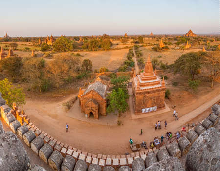 BAGAN, MYANMAR - FEBRUARY 22: Sunset panorama over pagodas from Shwesandaw pagoda while tourists sightseeing around on February 22, 2013 in Bagan, Myanmar.のeditorial素材