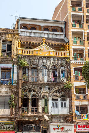 YANGON, MYANMAR - MAR 1: Building in the city center with mixed styles from colonial and imperial time to modern styles and materials on Mar 1, 2012 in Yangon, Myanmar.のeditorial素材