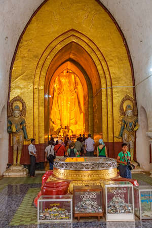 BAGAN, MYANMAR - FEBRUARY 23: Entrance to the Standing Buddha Gotama at west facing part of the Ananda temple with lot of tourists sightseeing on February 23, 2013 in Bagan, Myanmar.のeditorial素材