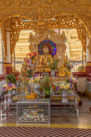 MANDALAY, MYANMAR - FEBRUARY 26: Buddha altar at Kuthodaw Pagoda on February 26, 2012 in Mandalay, Myanmar. Donation box in the front.のeditorial素材