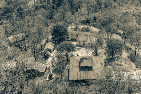 View from the top of Popa Taungkalat monastery to the Popa village and monastery at hte base of the...