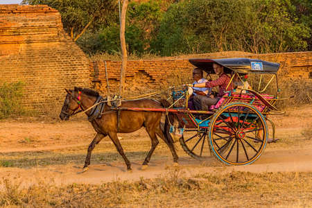 BAGAN, MYANMAR - FEBRUARY 23: Tourist taking cart ride to watch the sunset on the ancient pagoda on February 23, 2013 in Bagan, Myanmar.のeditorial素材