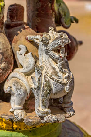 BAGAN, MYANMAR - FEBRUARY 23: Dragon decoration detail on an old praying bell in front of the Ananda temple on February 23, 2013 in Bagan, Myanmar.のeditorial素材