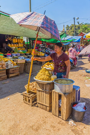 PINDAYA, MYANMAR - FEBRUARY 27:  Women are selling vegetables at the local market on February 27, 2013 in Pindaya, Myanmar.のeditorial素材