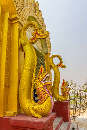 MOUNT POPA, MYANMAR - FEBRUARY 24: Popa Votive pagoda entrance with dragon figures at Taungkalat monastery atop an outcrop of Mount Popa volcano on February 24, 2013 in Mount Popa, Myanmar.のeditorial素材