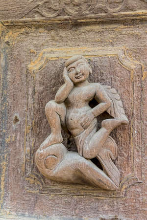 MANDALAY - FEBRUARY 26: Carving detail on the facade of Shwenandaw Kyaung Temple or Golden Palace Monastery on February 26, 2013 in Mandalay, Myanmar. Originaly gilded when was built in 1880のeditorial素材