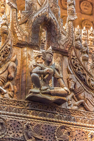 MANDALAY - FEBRUARY 26: Carving detail on the facade of Shwenandaw Kyaung Temple or Golden Palace Monastery on February 26, 2013 in Mandalay, Myanmar. Originaly gilded when was built in 1880のeditorial素材