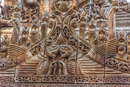 MANDALAY - FEBRUARY 26: Carving detail on the facade of Shwenandaw Kyaung Temple or Golden Palace Monastery on February 26, 2013 in Mandalay, Myanmar. Originaly gilded when was built in 1880のeditorial素材