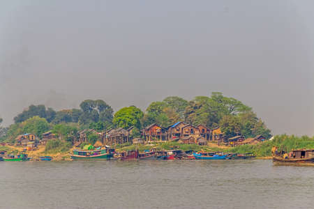 MANDALAY - FEBRUARY 26: Lot of transport ships in harbor on the bank of the Irrawaddi river on February 26, 2013 in Mandalay, Myanmar.のeditorial素材