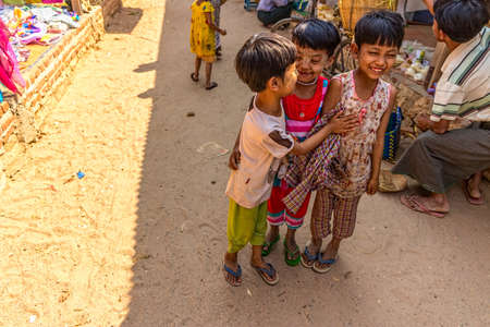 BAGAN, MYANMAR - FEBRUARY 24: Happy Burmese children on a local market on February 24, 2013 in Bagan, Myanmar.のeditorial素材