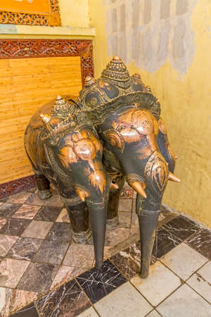 MANDALAY - FEBRUARY 25: People with soreness or pain come to rub the Mahamuni Khmer bronze statues in the same place where it hurts on February 25, 2013 in Mandalay, Myanmarのeditorial素材