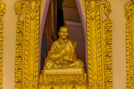 MANDALAY - FEBRUARY 26: Monk statue in the window of the small temple in Mingun on February 26, 2013 in Mandalay, Myanmar.のeditorial素材