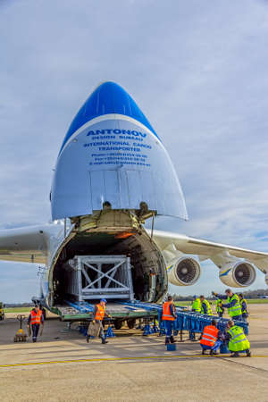 ZAGREB, CROATIA - NOVEMBER 10: Loading heavy weight cargo to the Antonov 225 Mriya airplane on November 10, 2013 Zagreb, Croatia. It is the biggest airplane in the world.のeditorial素材