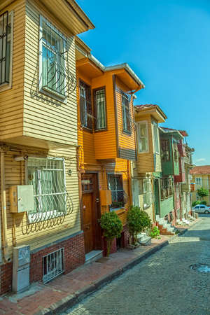 Street with typical old wooden traditional houses and filigree sidewalk in the od part of district Fatih のeditorial素材