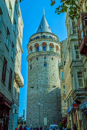 ISTANBUL, TURKEY - SEPTEMBER 28: View of the famous medieval landmark Galata Tower in the old narrow street in the city center on September 28th, 2013 Istanbul, Turkey.のeditorial素材