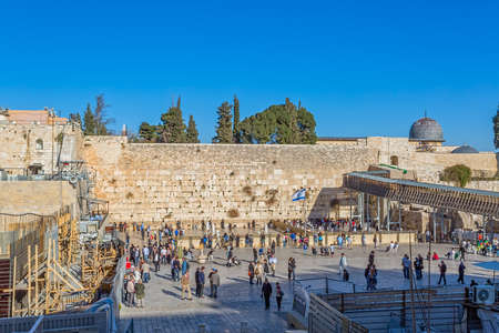 JERUSALEM, ISRAEL - FEBRUARY 28, 2014: Tourists and prayers visiting and making their wishes at The Western Wall, Wailing Wall or Kotel witch is located in the Old City at the foot of the western side of the Temple Mount.のeditorial素材