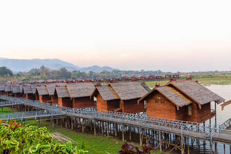 INLE LAKE   MYANMAR - FEBRUARY 28 2013  Replica of the traditional floating village engineered as a hotel with bungalows with tourists returning from a lake trip のeditorial素材