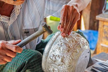 INDEIN   MYANMAR - FEBRUARY 28 2013  Traditional craft production of silverware 