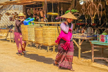 INDEIN   MYANMAR - FEBRUARY 28 2013  Two women leaving traditional market at Indein which is held every fifth day のeditorial素材