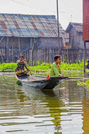 INLE LAKE   MYANMAR - FEBRUARY 28 2013  Leaving with the traditional motorized river boat のeditorial素材