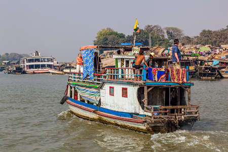 MANDALAY, MYANMAR - FEBRUARY 26, 2013: People on the ship leaves port of the Irrawaddi river.のeditorial素材