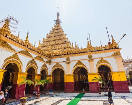 MANDALAY, MYANMAR - FEBRUARY 26, 2013: Buddhist believers in white and golden famous Mahamuni pagoda.のeditorial素材