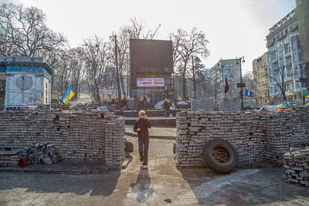 KIEV, UKRAINE - MARCH 22, 2014: People visiting barricades in front of entrance to the Dinamo Kiev...