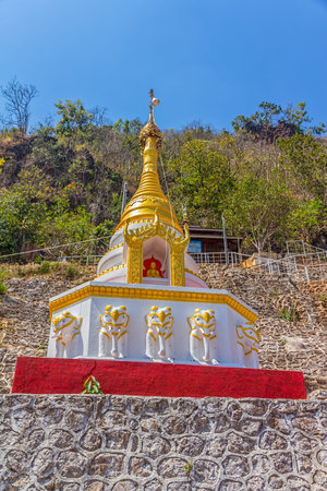 PINDAYA CAVES, MYANMAR - FEBRUARY 27, 2013: Small stupa with statues at the Entrance of the Pindaya caves, Buddhist shrine where thousands of Buddha images have been consecrated for worship over the centuries.のeditorial素材