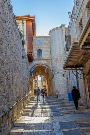 JERUSALEM, ISRAEL - FEBRUARY 28, 2014: People sightseeing old narrow streets in the Old City near Jaffa gate.のeditorial素材