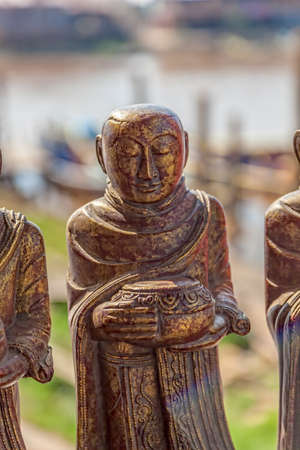 INLE LAKE, MYANMAR - FEBRUARY 28, 2013: Statue of a monk in front of the temple.のeditorial素材