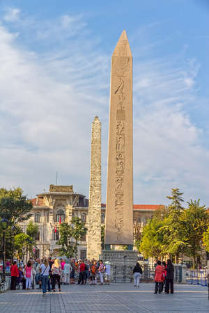 ISTANBUL, TURKEY - SEPTEMBER 27, 2013: Tourists visiting The Obelisk of Theodosius at Sultanahmet park. It is the Ancient Egyptian obelisk of Pharaoh Tutmoses III.のeditorial素材