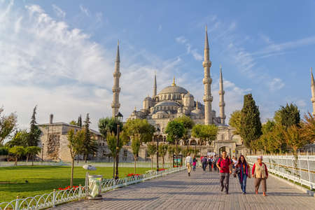ISTANBUL, TURKEY - SEPTEMBER 27, 2013: Tourist group walking around Blue mosque and Sultanahmet park. The biggest mosque in Istanbul of Sultan Ahmed (Ottoman Empire).のeditorial素材