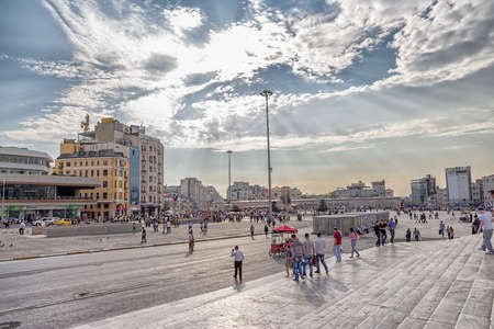 ISTANBUL, TURKEY - SEPTEMBER 28, 2013: People walking or resting on Taksim Square around Republic Monument.のeditorial素材