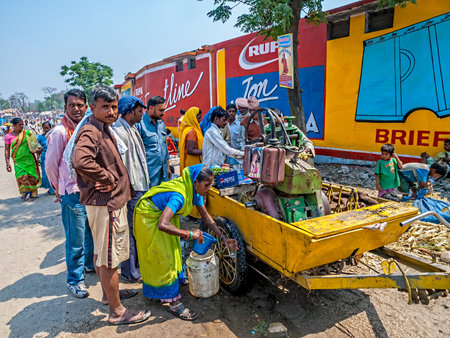 HARIDWAR, INDIA - APRIL 14, 2010: People around drinking water at the Kumbh Mela, a mass Hindu...
