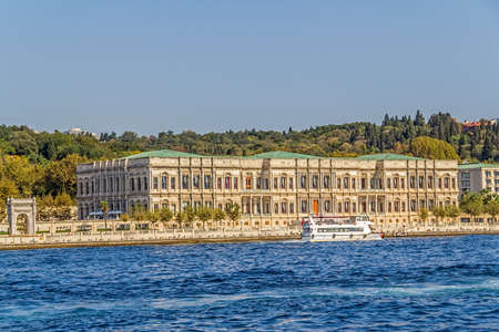 ISTANBUL, TURKEY - SEPTEMBER 29, 2013: Tourist boat floats in front of the Ciragan palace a former Ottoman palace is now a five-star hotel of the Kempinski Hotels chain, sailing Bosporus.のeditorial素材