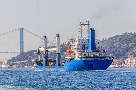 The ship sails Bosphorus near the First Bosphorus bridge on sunny autumn day.の写真素材
