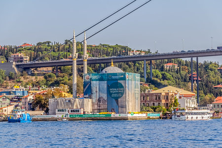 ISTANBUL, TURKEY - SEPTEMBER 29, 2013: View of the OrtakÃÂ¶y Mosque in restoration and First Bosphorus Bridge, sailling Bosporus.のeditorial素材
