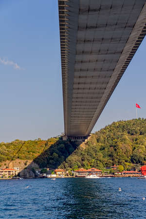 View of the Fatih Sultan Mehmet Bridge and residental buildings on asian side sailing Bosporus.の写真素材