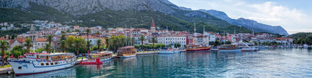 MAKARSKA, CROATIA - JULY 22, 2014: Panorama of the city harbor with moored tourist ships in the summer morning on the waterfront.のeditorial素材