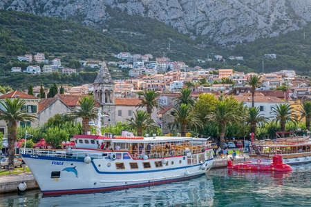 MAKARSKA, CROATIA - JULY 22, 2014: Tourist boat Voga and half-submarine  in the city harbor at summer morning.のeditorial素材