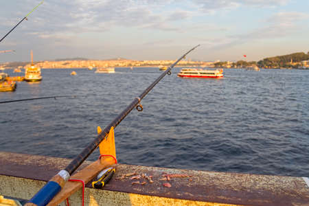 Looking towards the sea from the Galata Bridge with fishing rod and lures on the fence.の写真素材